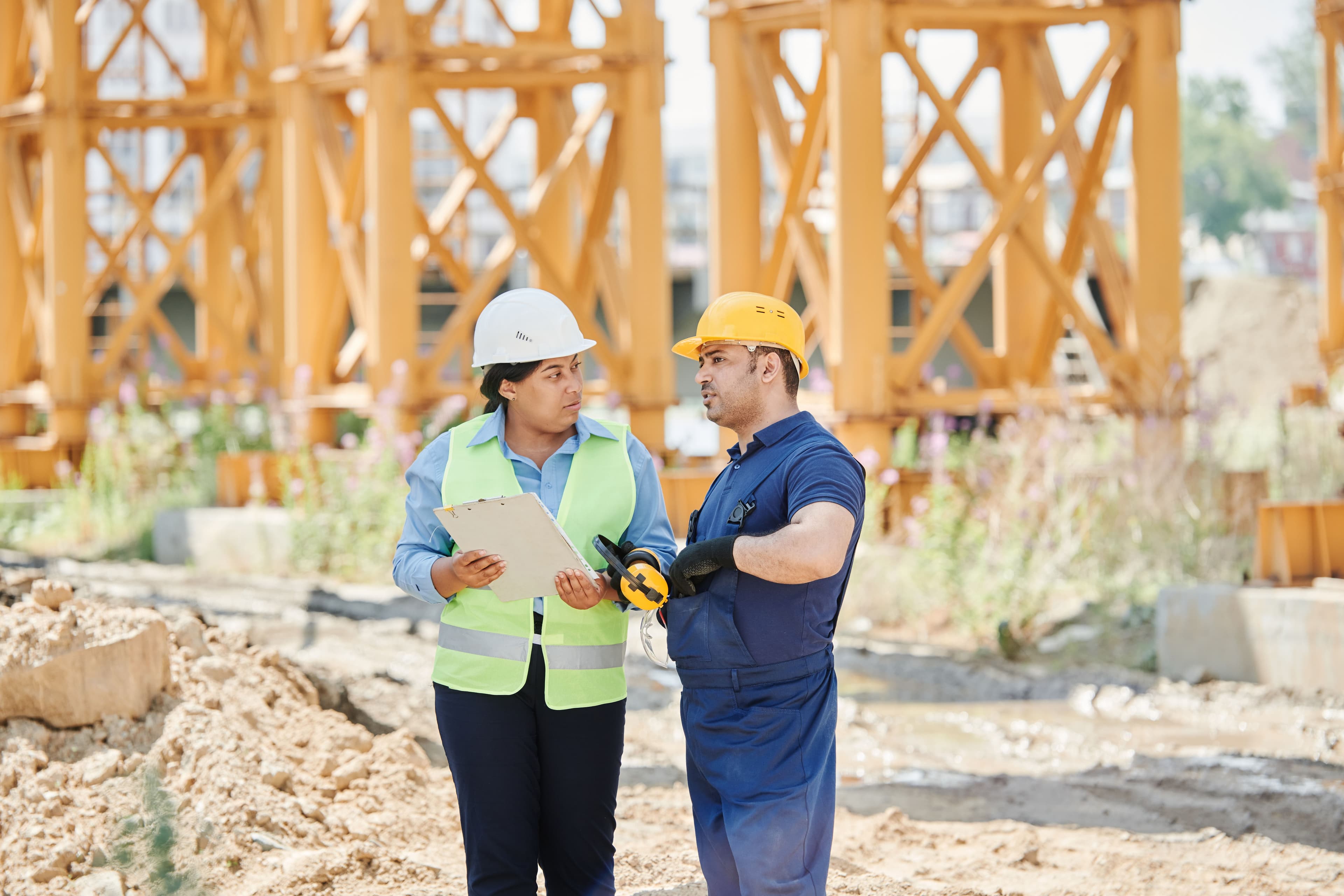 Construction workers reviewing field documentation on site