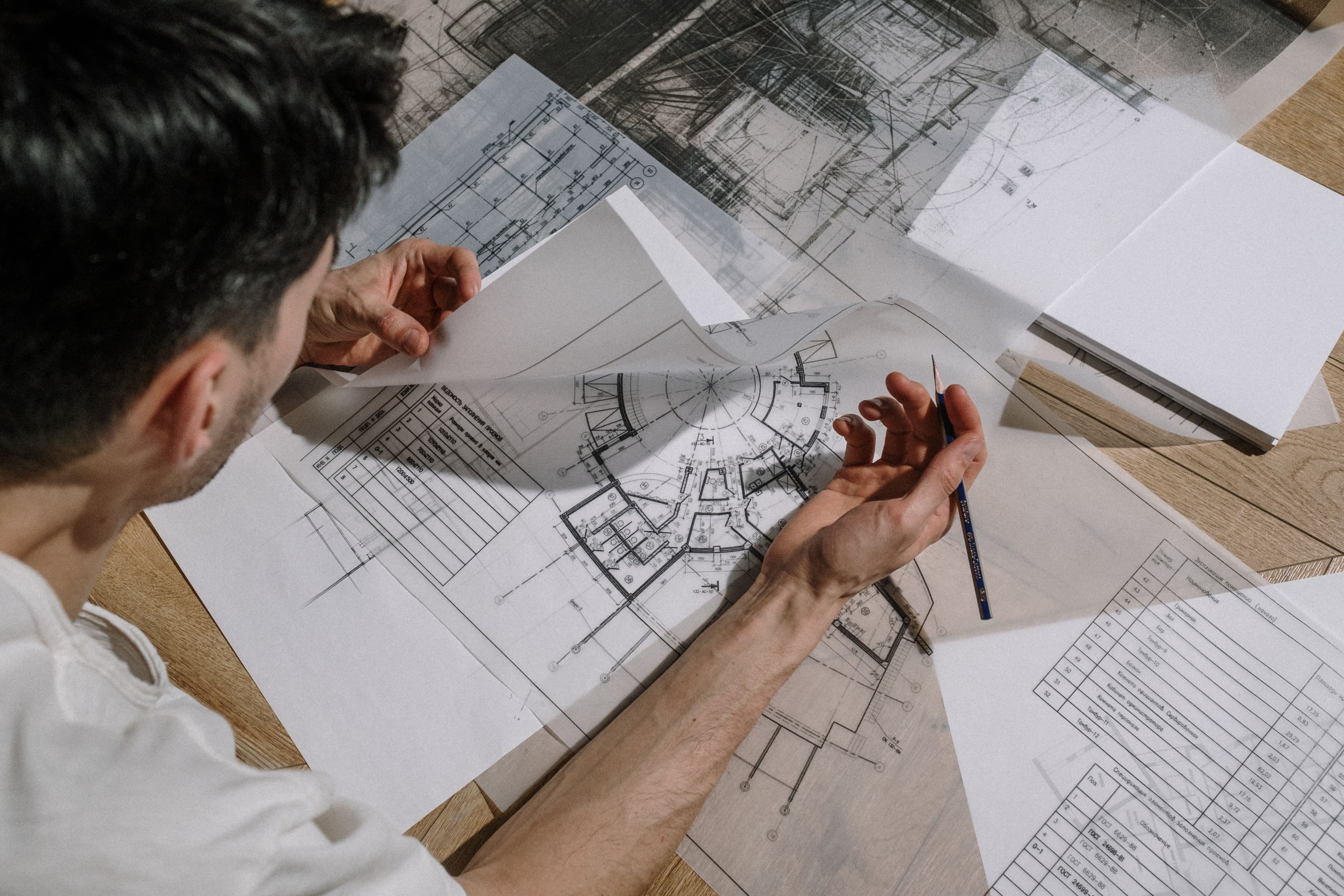 An architect reviewing detailed construction blueprints