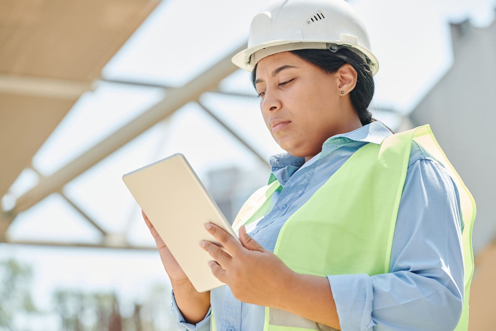 A construction professional reviewing data on a tablet on site